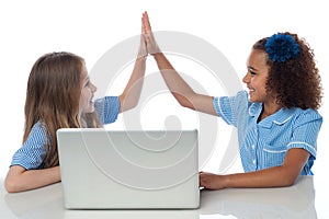 Cute little school girls with laptop