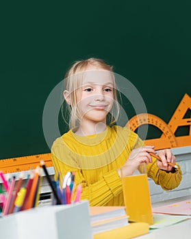 Cute little school kid girl study in a classroom. Genius child, knowledge day. Kids education and knowledge.