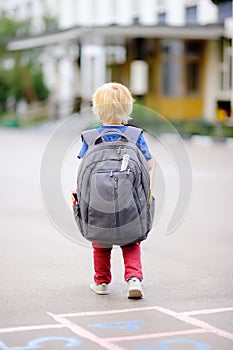 Back to school concept. Young student with his backpack