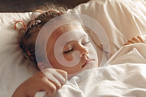 Cute little sick girl sleeping in her bed