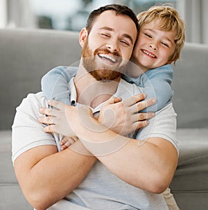 Cute little smiling caucasian boy hugging dad from behind at home. Carefree happy dad receiving love and affection from