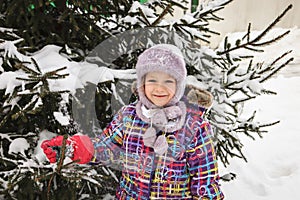 Cute little smiling girl with christmas tree. Family, tradition, celebration concept.