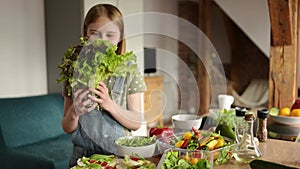 Cute Little Smiling Girl Playing With A Fresh Green Salad