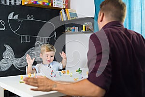 Cute little toddler boy at child therapy session.