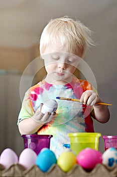 Cute Little Toddler Boy Painting on an Easter Egg