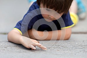 Cute little toddler boy, playing with ladybird
