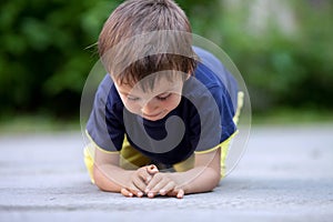 Cute little toddler boy, playing with ladybird