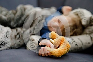 Cute little toddler girl sleeping in bed. Adorable baby child dreaming, healthy sleep of children by day.