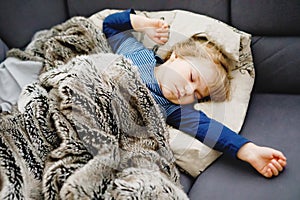 Cute little toddler girl sleeping in bed. Adorable baby child dreaming, healthy sleep of children by day.