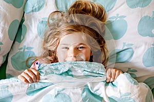 Cute little toddler girl sleeping in bed. Adorable preschool child dreaming, healthy sleep of children by day. Deep