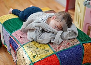 cute little toddler sleeping on a futon