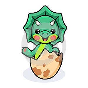 Cute little triceratops dinosaur cartoon hatching from egg