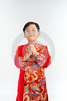 Cute little Vietnamese boy in ao dai dress smiling. Tet Holiday