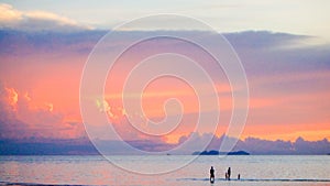 Cute lovely family walking on beach beautiful pastel sunset