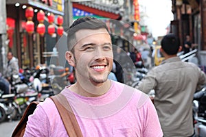 Cute man in crowded Asian street