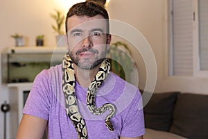 Cute man holding exotic ball python