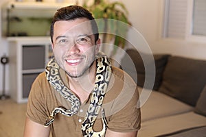 Cute man holding exotic ball python