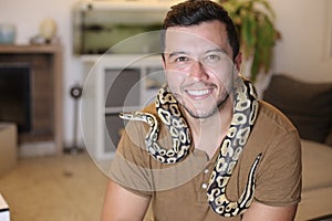 Cute man holding exotic ball python
