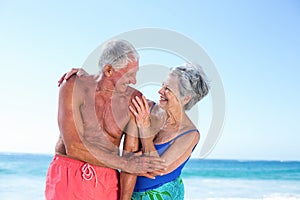 Cute mature couple embracing on the beach