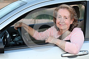 Cute mature female driver smiling