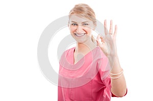 Cute medical female nurse making okay gesture