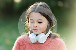 Cute melomane. Little girl child wearing headphones. Happy child enjoy listening to music on the go. Adorable little