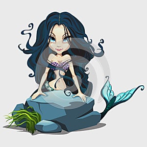 Cute mermaid with long black hair behind a rock