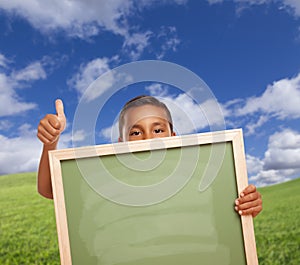 Cute Mexican Boy Gives Thumbs Up in Field Holding Blank Chalk Board