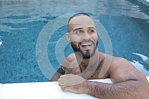 Cute Middle Eastern man swimming pool