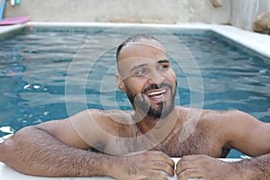 Cute Middle Eastern man swimming pool