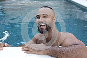 Cute Middle Eastern man swimming pool