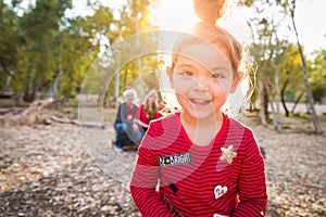 Cute Mixed Race Baby Girl Christmas Portrait With Family Behind