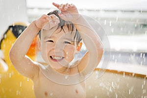 Cute Mixed Race Boy Having Fun at the Water Park