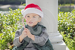 Cute Mixed Race Boy With Santa Hat and Candy Cane