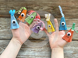 Cute monsters on children& x27;s hand, kids DIY from recycling egg box.
