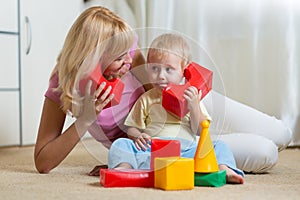 Cute mother and child boy role playing together at home