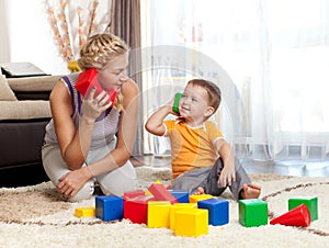 Cute mother and kid boy playing together