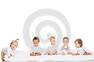 cute multicultural toddlers holding smartphones