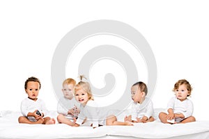 cute multicultural toddlers holding smartphones