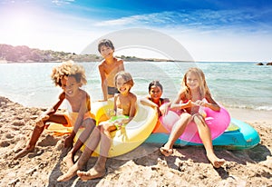 Cute multiethnic kids spending summer on the beach