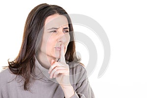 Cute mysterious woman showing silence shh sign holding finger on lips having secret  on white background