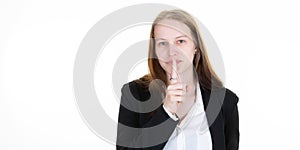 Cute mysterious woman showing silence sign holding forefinger on lips having a secret isolated on white background