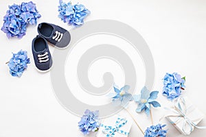 Cute newborn baby boy shoes with festive decoration. Baby shower