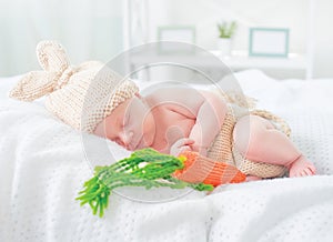 Cute newborn baby boy wearing knitted bunny costume