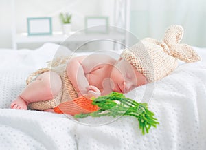 Cute newborn baby boy wearing knitted bunny costume