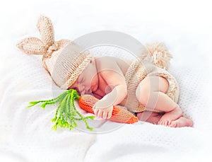 Cute newborn baby boy wearing knitted bunny costume