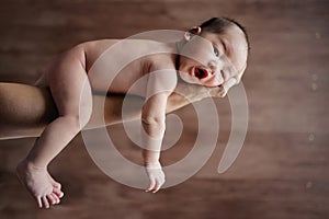 cute newborn baby carried by her mother& x27;s hand