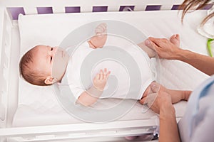 Cute newborn baby in a changing table