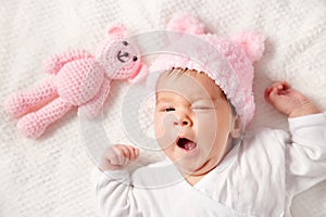 Cute newborn baby girl lying in the bed