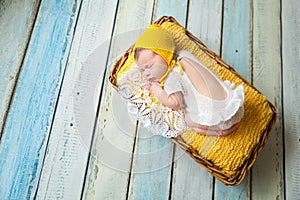 Cute newborn baby girl in a pink knit romper